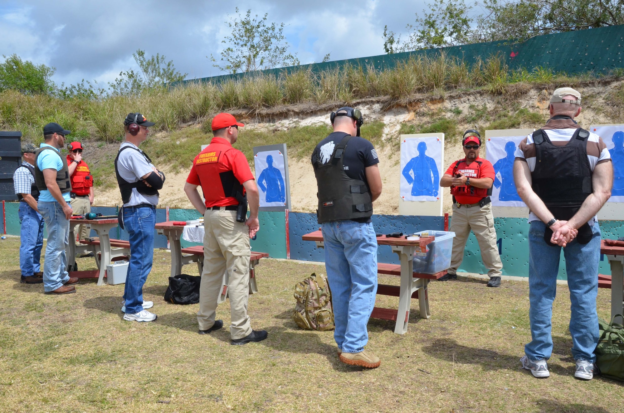 Members of the Air Force Technical Applications Center, Patrick AFB, Fla., listen to master lead instructor Larry Plotkin (second from right) give instructions on how to stand during the live fire portion of the Brevard County Sheriff’s Office’s Self Defense Through Tactical Shooting and Decision Making course March 25, 2017. (U.S. Air Force photo by Susan A. Romano)