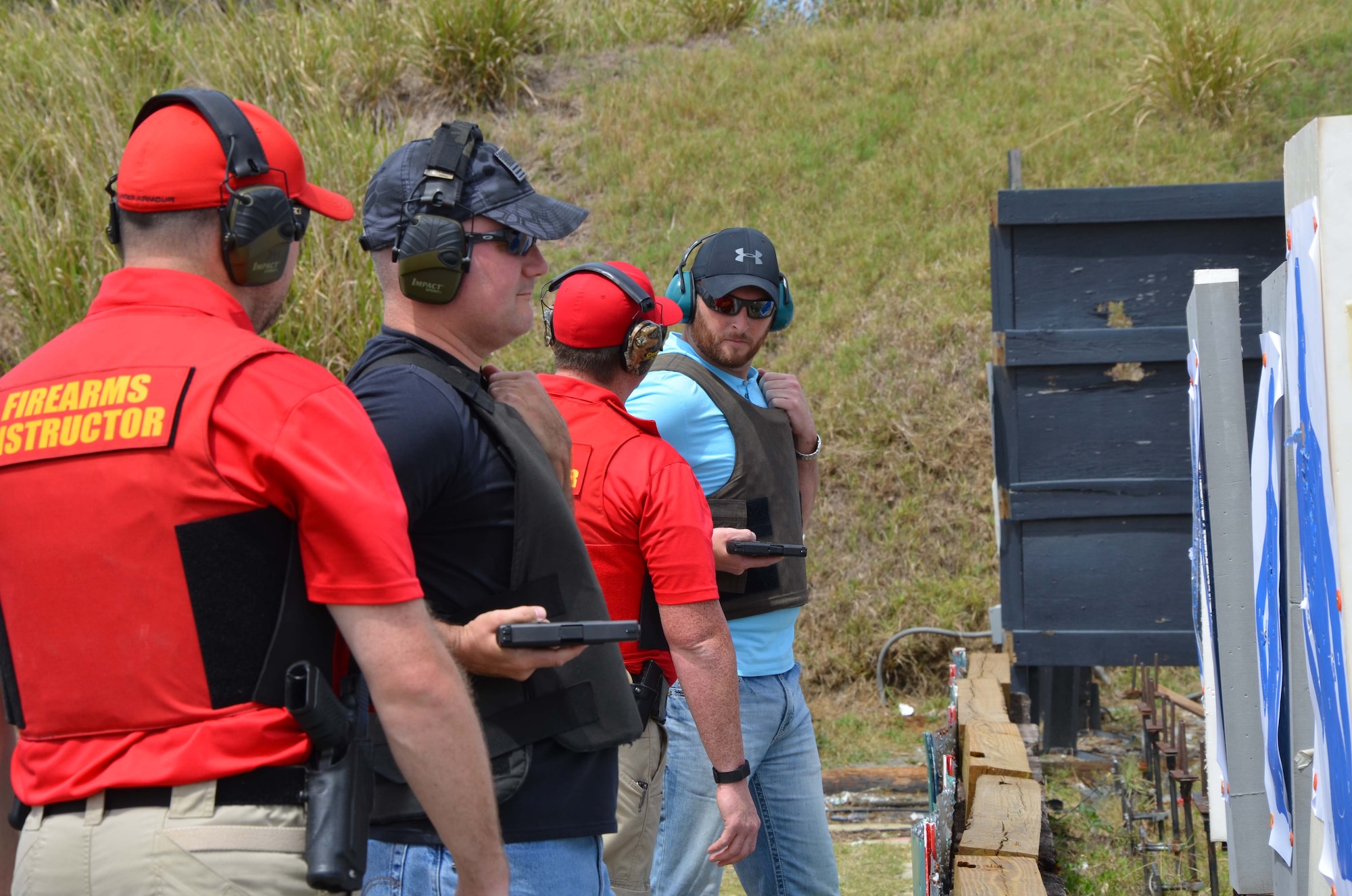 Senior Master Sgt. Chad Madore and Troy Lawson, both members of the Air Force Technical Applications Center, Patrick AFB, Fla., experience hip shooting techniques under the watchful eye of Brevard County Sheriff’s Office range deputies.  Madore and Lawson were part of a larger group from AFTAC who attended BCSO’s Self Defense Through Tactical Shooting and Decision Making course March 25, 2017.  (U.S. Air Force photo by Susan A. Romano)