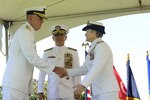 U.S. Coast Guard Rear Adm. Keith M. Smith welcomes Rear Adm. Donna L. Cottrell, USCG (center, Commander U.S. Pacific Command, Adm. Harry Harris, Jr., USN) during Joint Interagency Task Force West's 17th Change of Command Ceremony at Camp H. M. Smith, March 31, 2017. 