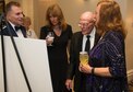 SCHRIEVER AIR FORCE BASE, Colo. -- 310th Bombardment Group alumni member, Cpl. Marion Hall, shows standers-by a photo of himself and his comrades taken 75 years ago while attending the 19th Annual Awards Banquet Saturday, Apr. 1st, 2017. The 310th Space Wing boasts a proud heritage that ties back to the Doolittle Raiders, who were members of the 310th Bombardment Group. (U.S. Air Force photo/Senior Airman Laura Turner)