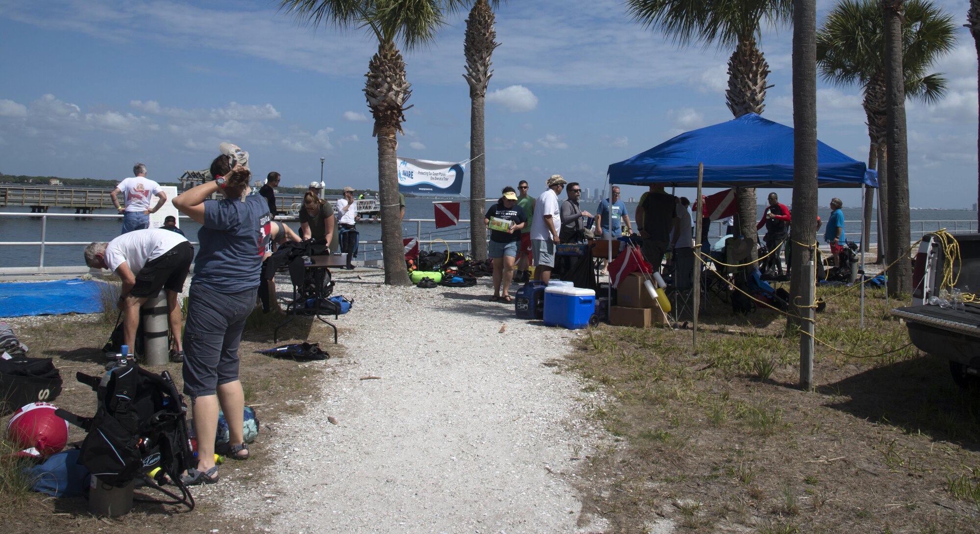 Volunteer divers setup diving gear and prepare for a safety briefing before the “Diving against Debris” cleanup event, March 26, 2017 at MacDill Air Force Base, Fla. Ed Krawczyk, the event coordinator, organized the event with members of the 6th Security Forces Squadron. (U.S. Air Force photo by Airman 1st Class Rito Smith)