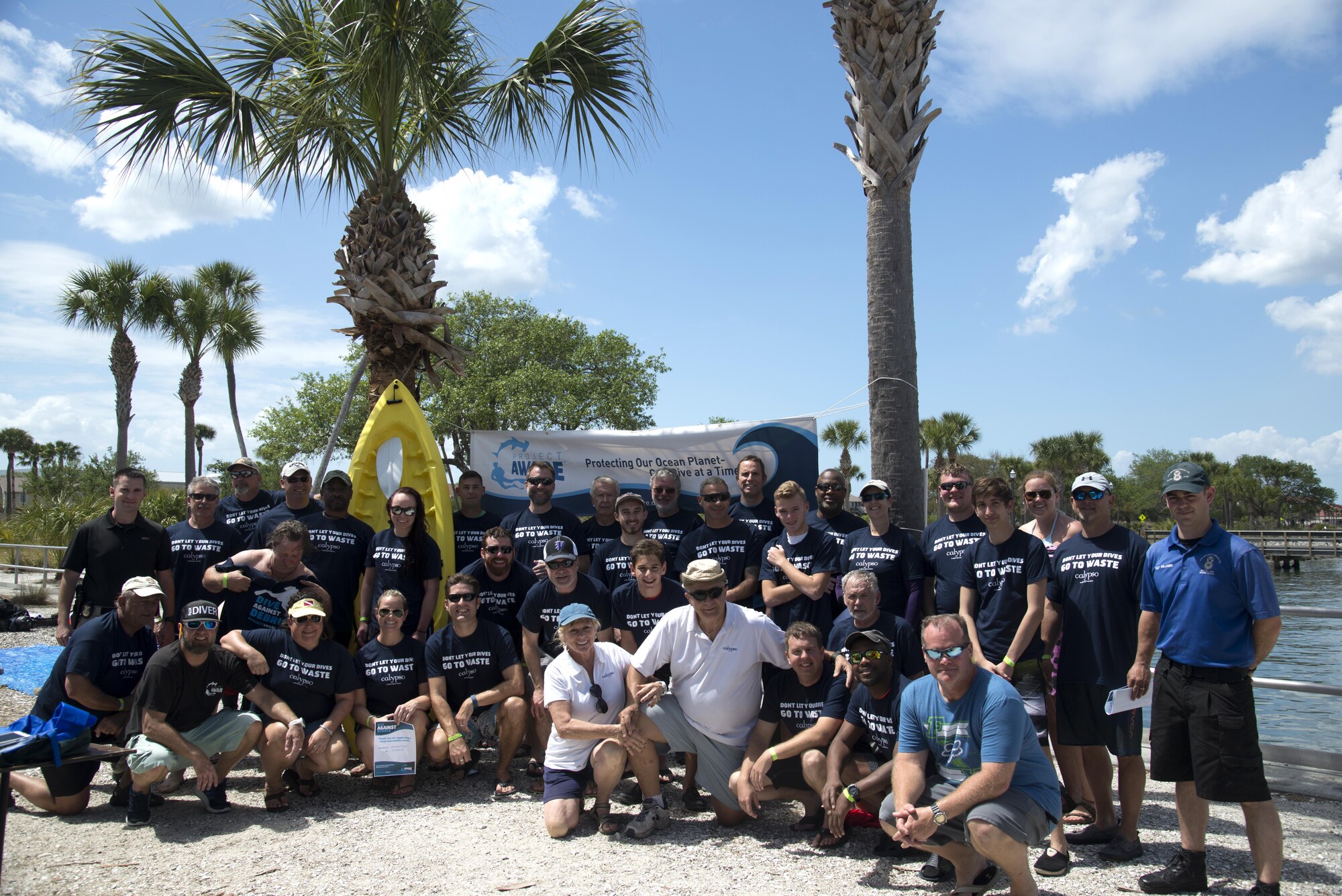 Volunteers pause for a group photo after the “Diving against Debris” event March 26, 2017 at MacDill Air Force Base, Fla. The military and civilian community came together to clean up the piers. (U.S. Air Force Photo by Airman 1st Class Rito Smith)