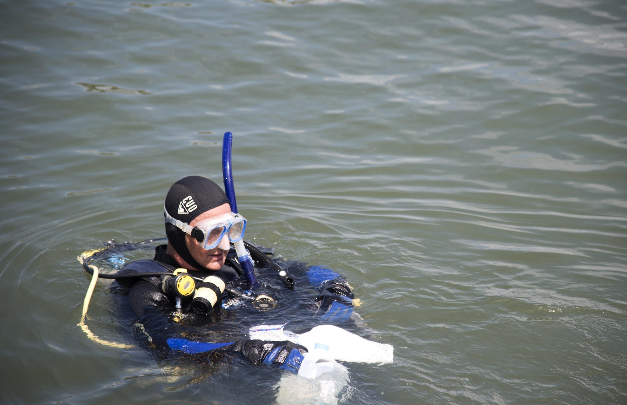 A volunteer diver searches for trash by the piers at MacDill Air Force Base, Fla., March 26, 2017. Civilian and military divers came together for the first-ever MacDill marine clean-up. (U.S. Air Force photo by Airman 1st Class Rito Smith) 