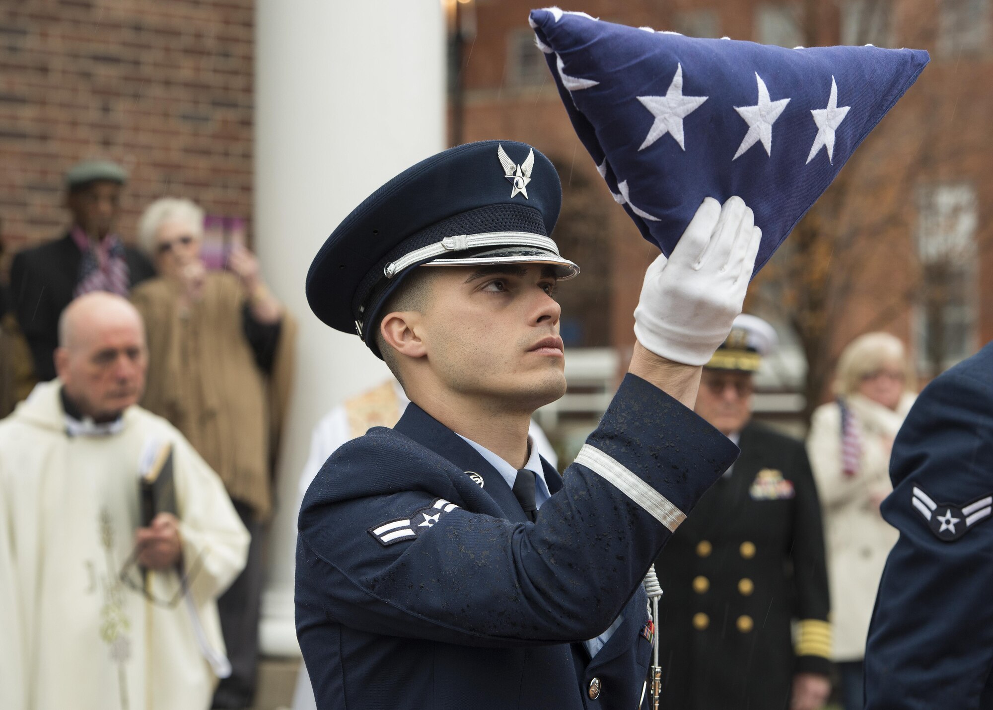 Airman 1st Class Joshua Ashe, Dover Air Force Base Honor Guard, inspects a folded flag during the funeral service of retired Maj. John L. Harrison, Jr., World War II veteran and Tuskegee Airman, March 31, 2017, at the Chapel of the Four Chaplains at the Navy Yard in Philadelphia, Pa. Ashe is normally assigned to the 436th Civil Engineer Squadron as a heating, ventilation and air conditioning technician. (U.S. Air Force photo by Senior Airman Zachary Cacicia)