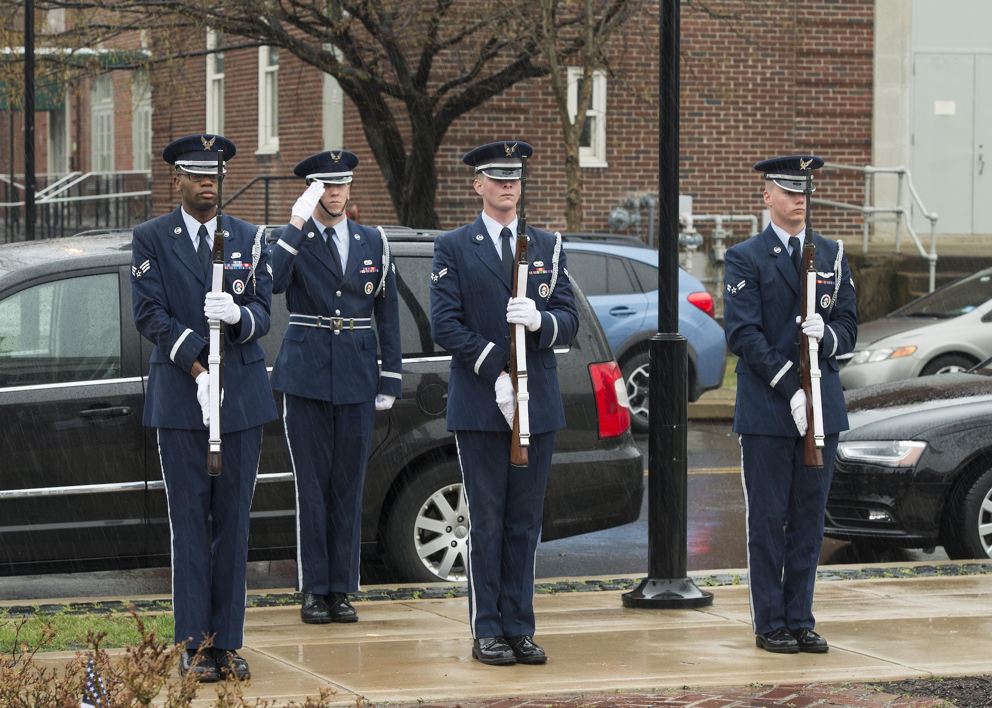 A Dover Air Force Base Honor Guard firing party presents arms during the funeral service of retired Maj. John L. Harrison, Jr., World War II veteran and Tuskegee Airman, March 31, 2017, at the Chapel of the Four Chaplains at the Navy Yard in Philadelphia, Pa. The firing party fired three three-round volleys. (U.S. Air Force photo by Senior Airman Zachary Cacicia)
