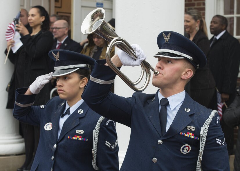 Airman 1st Class Cassandra Kalie salutes as Airman 1st Class Kyle Dillon plays taps during the funeral service of retired Maj. John L. Harrison, Jr., World War II veteran and Tuskegee Airman, March 31, 2017, at the Chapel of the Four Chaplains at the Navy Yard in Philadelphia, Pa. Kalie and Dillon are both members of the Dover Air Force Base Honor Guard. (U.S. Air Force photo by Senior Airman Zachary Cacicia)
