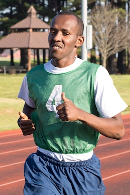 U.S. Air Force Reserve Senior Airman Kelvin Mwaniki, air transportation journeyman, 96th Aerial Port Squadron, gives a thumbs up in the run portion of his physical fitness assessment test at Little Rock Air Force Base, Ark., April 1, 2016. An outdoor or indoor track are available for runners depending on weather conditions at the time of testing. (U.S. Air Force photo by Master Sgt. Jeff Walston/Released)