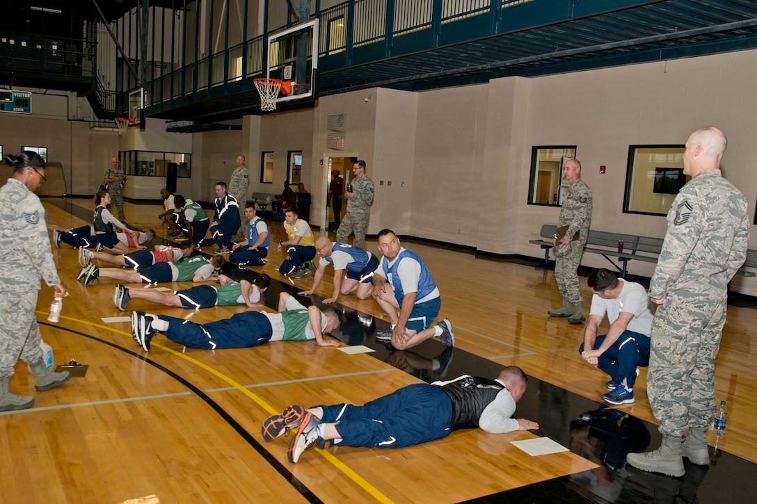 U.S. Air Force Reserve Airmen assigned to the 913th Airlift Group, prepare to perform as many push-ups as they can in one minute during their physical fitness assessment test at Little Rock Air Force Base, Ark., April 1, 2017. The Air Force uses overall composite fitness score and minimum scores per component based on aerobic fitness (1.5-mile timed run), body composition (abdominal circumference measurements) and muscular fitness components (push-ups and sit-ups) to determine overall fitness. (U.S. Air Force photo by Master Sgt. Jeff Walston/Released)