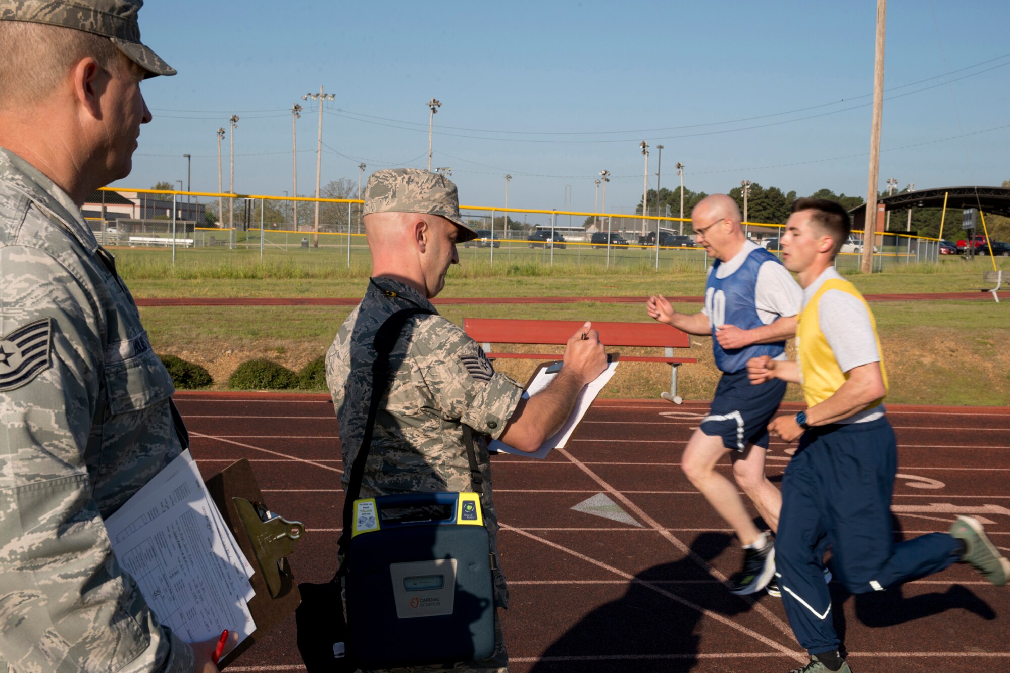 U.S. Air Force Reserve Tech. Sgt. Matt Cantone, calls out laps during the run portion of the physical fitness assessment test for the Airmen assigned to the 913th Airlift Group at Little Rock Air Force Base, Ark., Jan. 9, 2016. Cantone, an air ground equipment technician assigned to the 913th Maintenance Squadron, volunteered as a Physical Training Leader and monitors and records scores for fellow Airmen as they completed their tests. (U.S. Air Force photo by Master Sgt. Jeff Walston/Released)