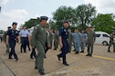 Royal Thai air force Group Captain Supijjarn Thamwatharsaree (left) walks with Royal Thai air force Air Chief Mashal Surasak Toongtong (center), Chief of the Air Staff for the RTAF and the official party, after their arrival at the closing ceremony for Cope Tiger 17 at Korat Royal Thai Air Force Base, Thailand, March 31, 2017. The annual multilateral exercise is aimed at improving combined combat readiness and interoperability between the Republic of Singapore air force, Royal Thai air force, and U.S. Air Force, while concurrently enhancing the three nations&#39; military relations.  (U.S. Air Force photo by Staff Sgt. Kamaile Chan)