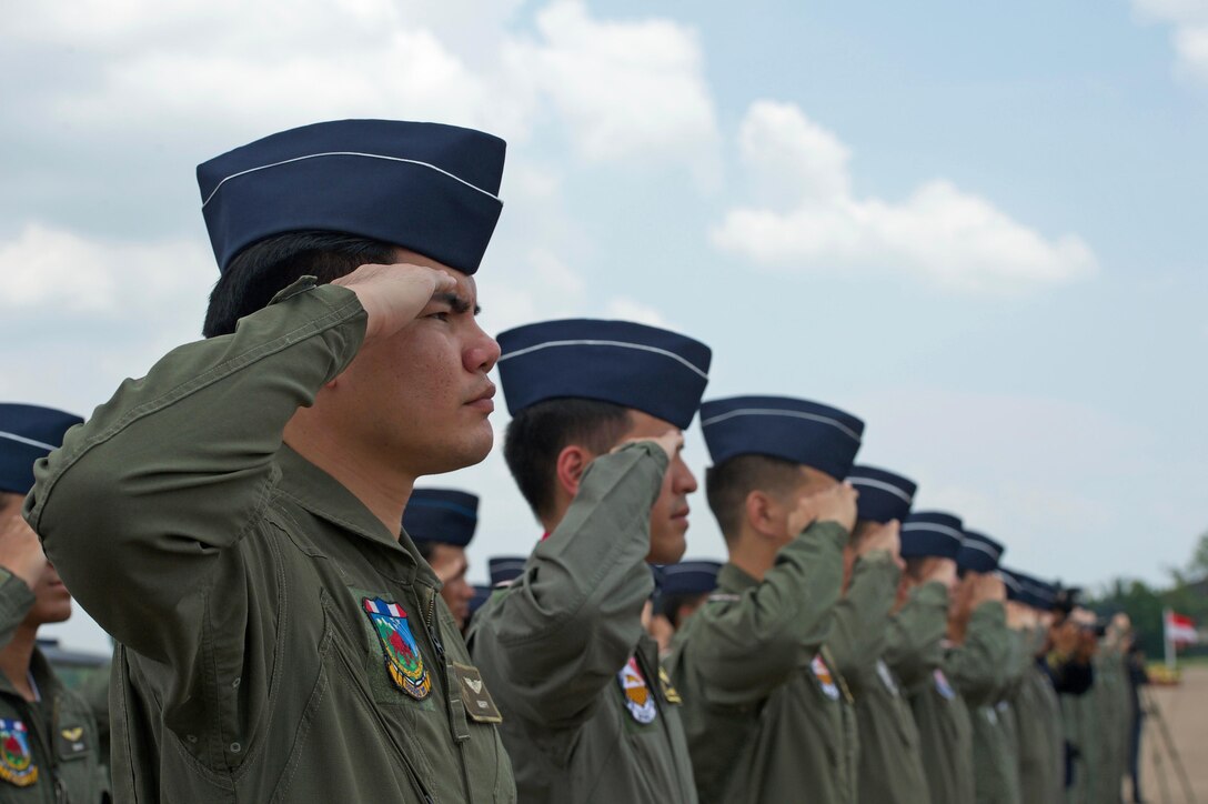 Royal Thai air force pilots perform a hand salute during the closing ceremony for Cope Tiger 17 at Korat Royal Thai Air Force Base, Thailand, March 31, 2017. The annual multilateral exercise is aimed at improving combined combat readiness and interoperability between the Republic of Singapore air force, Royal Thai air force, and U.S. Air Force, while concurrently enhancing the three nations' military relations.  (U.S. Air Force photo by Staff Sgt. Kamaile Chan)