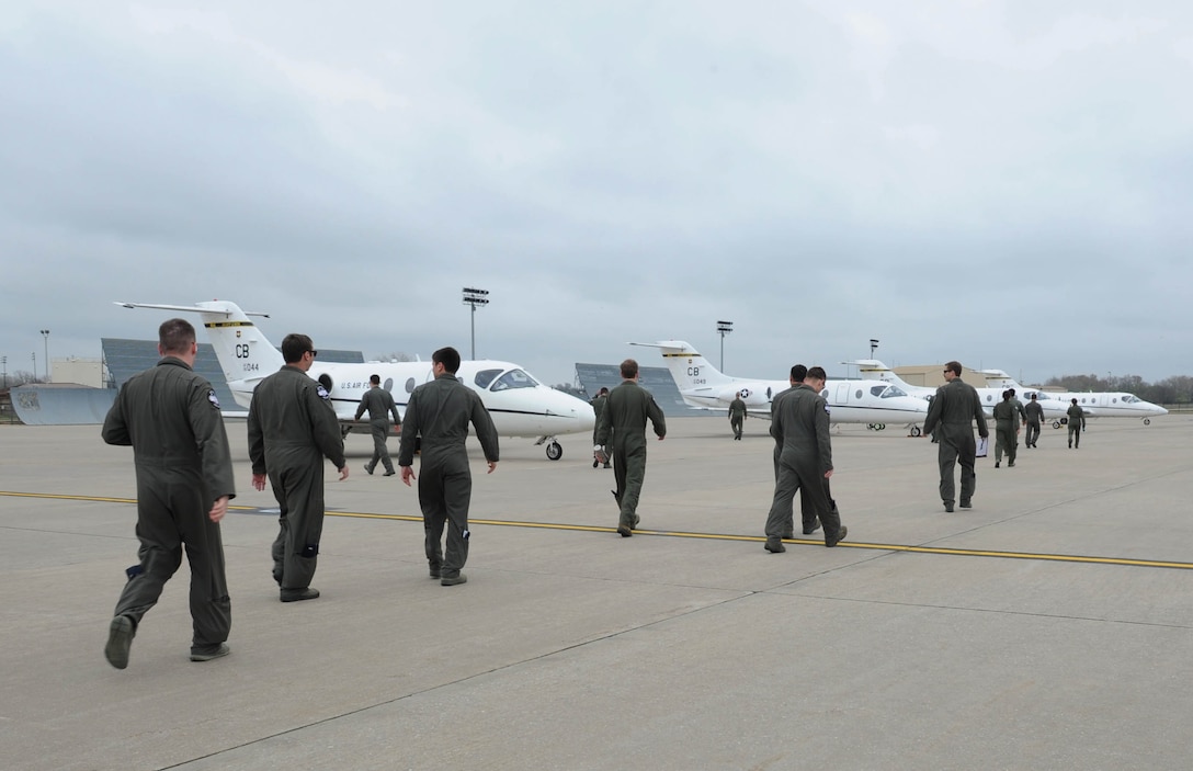 First Assignment Instructor Pilots assigned to the 48th Flight Training Squadron, walk back to their aircraft after visiting McConnell Air Force Base, Kan. The T-1 Jayhawk instructor pilots, from Columbus AFB, Mississippi, toured several bases to learn more about various aircraft and missions they may be assigned to in the future. (U.S. Air Force photo/Senior Airman Tara Fadenrecht)
