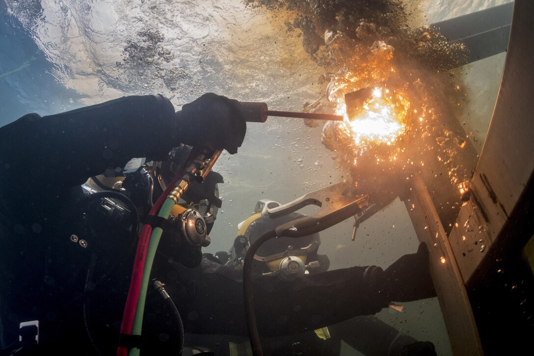 Navy Petty Officer 3rd Class Thomas Dahlke cuts a piece of steel in a training pool at the South Korean Naval Education and Training Command during exercise Foal Eagle in Jinhae, South Korea, March 31, 2017. Dahlke is an equipment operator assigned to Underwater Construction Team 2. The annual training exercise enhances the readiness of U.S. and South Korean forces and their ability to work together during a crisis. Navy photo by Chief Petty Officer Brett Cote