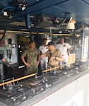 USNS Pathfinder Capt. Thomas Pearse-Drance explains bridge operations to Commander, U.S. Pacific Command, Adm. Harry Harris when he came aboard the T-AGS 60 class ship on March 30, in Pearl Harbor to gain a better understanding of the oceanographic products and processes the ship crew provides to the Department of Defense.