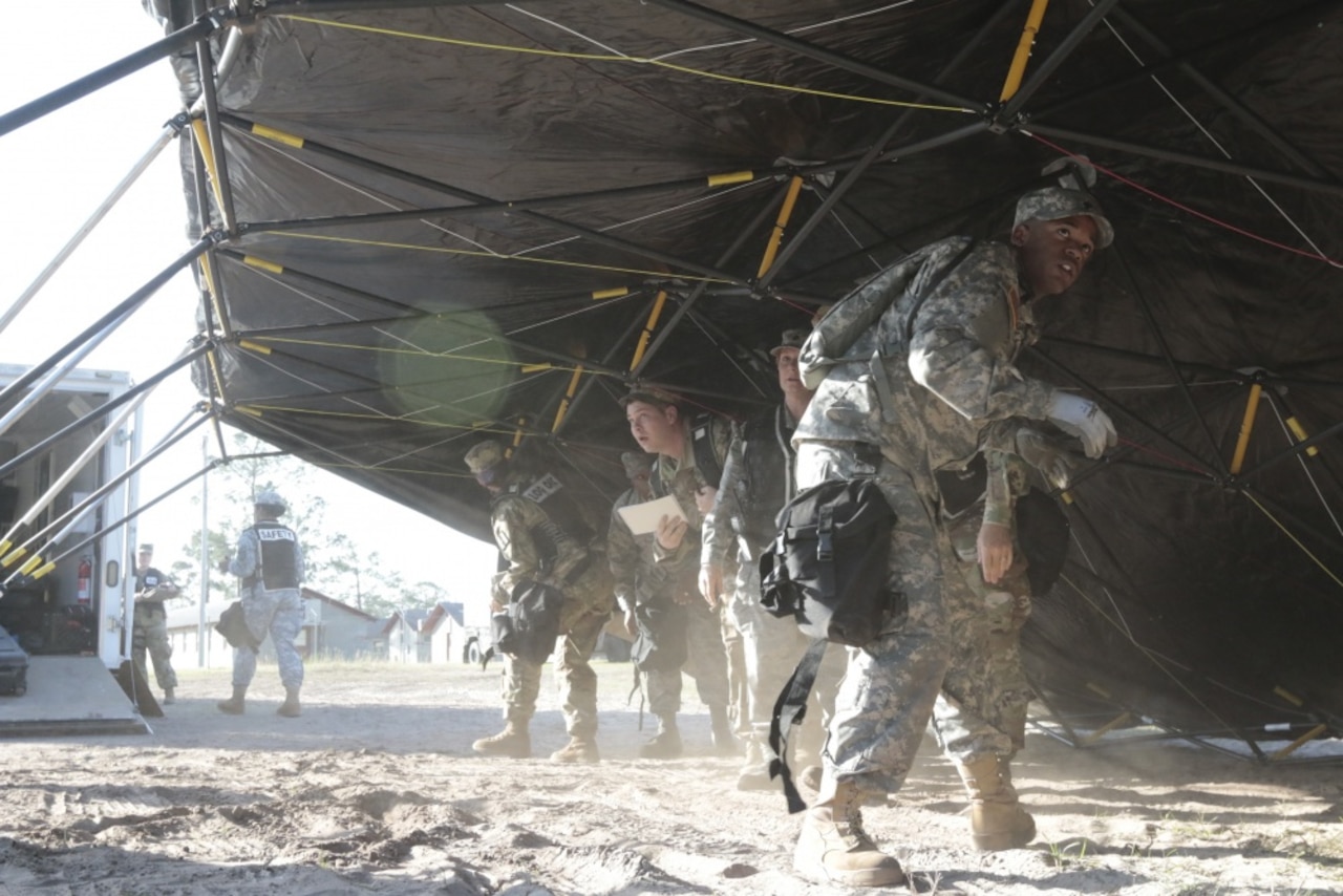 Soldiers and airmen of the Georgia National Guard's Joint Task Force 781 Chemical, Biological, Radiological, Nuclear and Explosives (CBRNE) set up a headquarters tent at Fort Stewart, Ga., as part of Vigilant Guard 2017, a statewide emergency response exercise, March 27, 2017. Army photo by Sgt. Moses Howard II