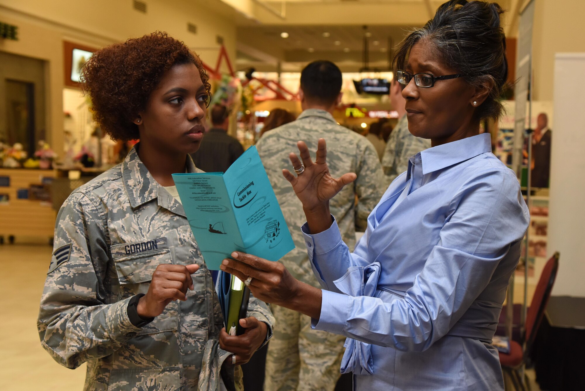 Lutrician James, Base Operations Support education and training specialist, provides information to Senior Airman Adrienne Gordon, 81st Dental Squadron dental lab technician, during the Spring Education Information Fair at the base exchange, March 29, 2017, on Keesler Air Force Base, Miss. The event is held to allow Keesler personnel the opportunity to explore higher education options. (U.S. Air Force photo by Kemberly Groue)