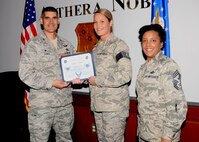 Tech. Sgt. Ashley Hall, 42nd Aerospace Medicine Squadron dental technician, receives a certificate of promotion from Col. Eric Shafa, 42nd Air Base Wing Commander, and Chief Master Sgt. Erica Shipp, 42nd Air Base Wing Command Chief, April 3, 2017, Maxwell Air Force Base, Ala. Hall was selected for step promotion due to her exemplary performance as a non-commissioned officer. (U.S. Air Force photo/ Senior Airman Alexa Culbert)