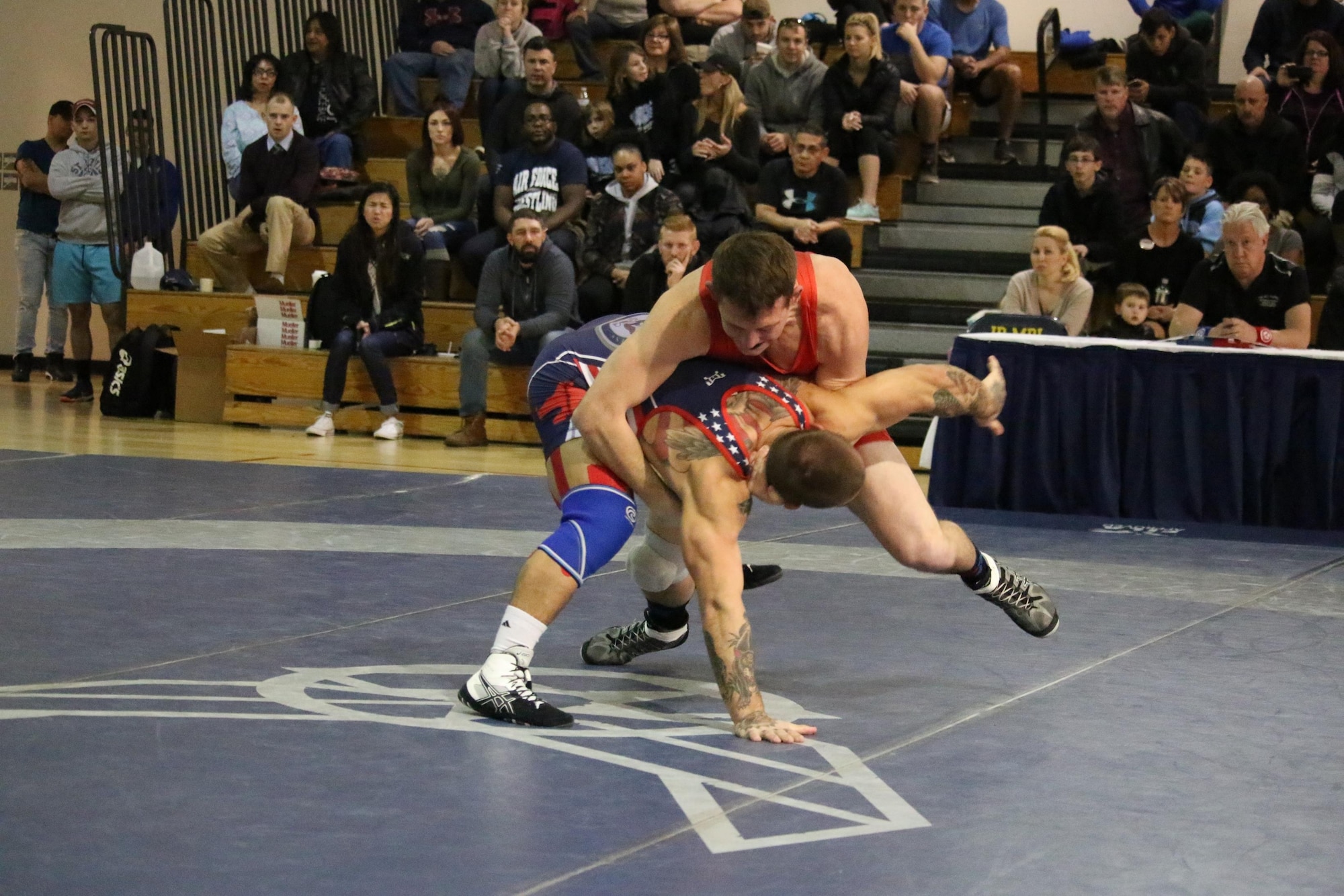 1st Lt. Brandon Mueller, in red, grapples with the Navy's Petty Officer Third Class Blake Borges at the Armed Forces Wrestling Championships Feb. 26 at Joint Base McGuire-Dix-Lakehurst, N.J. Mueller, a physicist with the Air Force Research Laboratory’s Space Vehicles Directorate, captured two second place medals at the event, earning him an invite to the WTT tournament. 