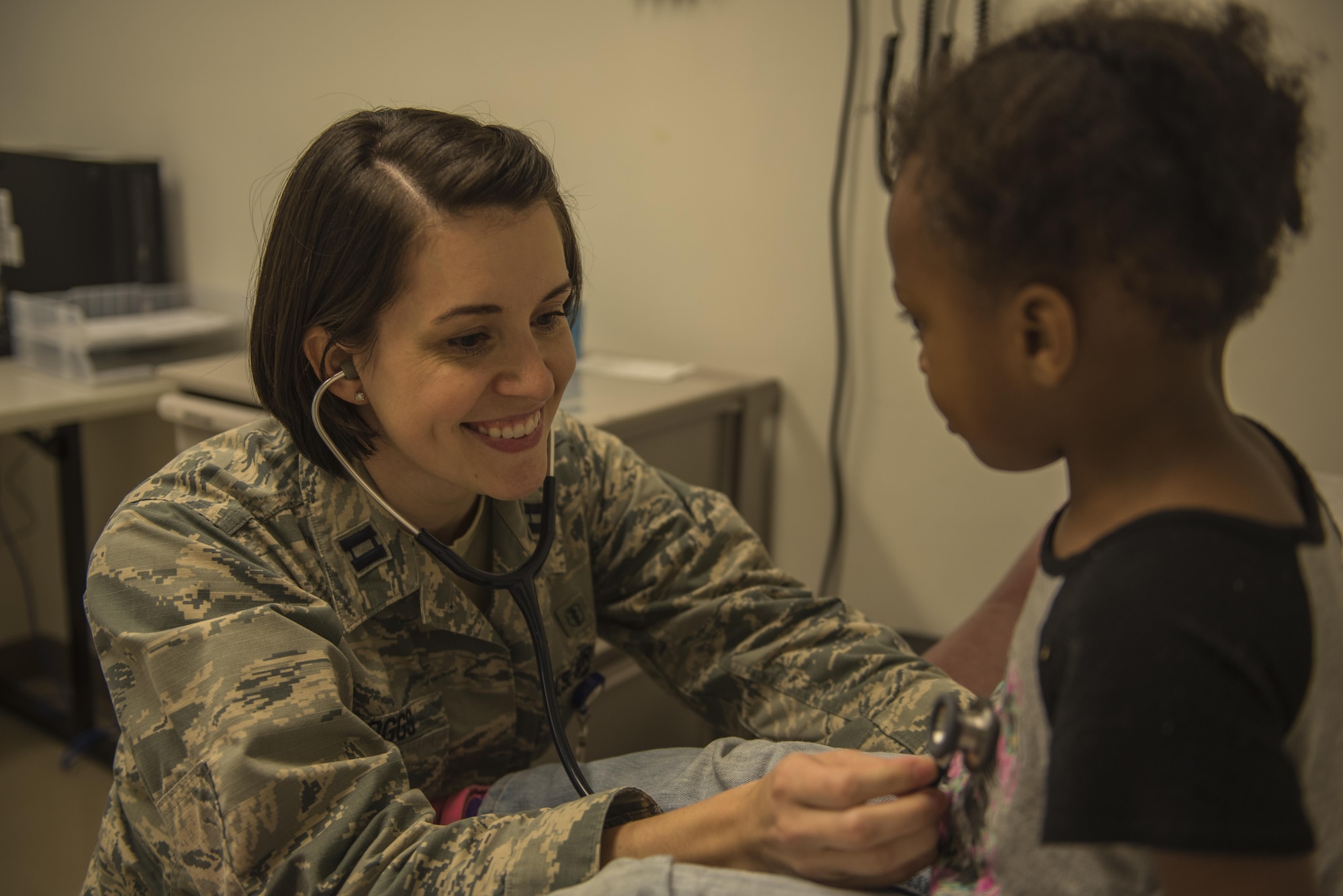 U.S. Air Force Capt. Cathy Boggs, the medical director of pediatrics with the 18th Medical Group, checks a patient in the pediatrics wing of the Kadena Clinic on Kadena Air Base, Japan. Preventative medicine is a large part of pediatrics and a key part is proper education of parents and other caretakers. (U.S. Air Force photo by Senior Airman Nick Emerick/Released)