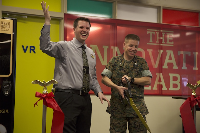 CAMP FOSTER, OKINAWA, Japan— Devin Farmer, left, and Col. William L DePue cut a ribbon March 27 during the grand opening of the Innovation Lab at the Camp Foster Library, Okinawa, Japan. The Innovation Lab features two Oculus Rifts, 3-D printers and an interactive robot. Farmer is the supervisory librarian for the Camp Foster Library. DePue is the Camp Foster camp commander and the Headquarters and Support Battalion, Marine Corps Installations Pacific-Marine Corps Base Camp Butler, Japan. (U.S. Marine Corps photo by Cpl. Jessica Collins)