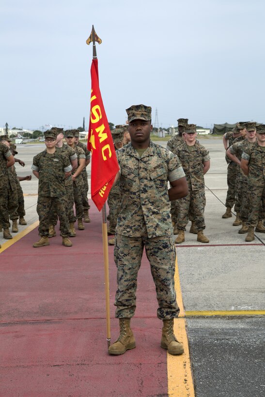 MCAS FUTENMA, OKINAWA, Japan— Cpl. Saamad Mitchell holds the Headquarters and Headquarters Squadron guideon March 29 during an award ceremony on Marine Corps Air Station Futenma. H&HS received the 2016 National Defense Transportation Association Military Unit of the Year Award for their outstanding service in the field of transportation and logistics. H&HS went head-to-head against the other branches of service for this award and came out on top.  Mitchell is a flight clearance supervisor with H&HS, MCAS Futenma, Marine Corps Installations Pacific. (U.S. Marine Corps photo by Cpl. Jessica Collins)