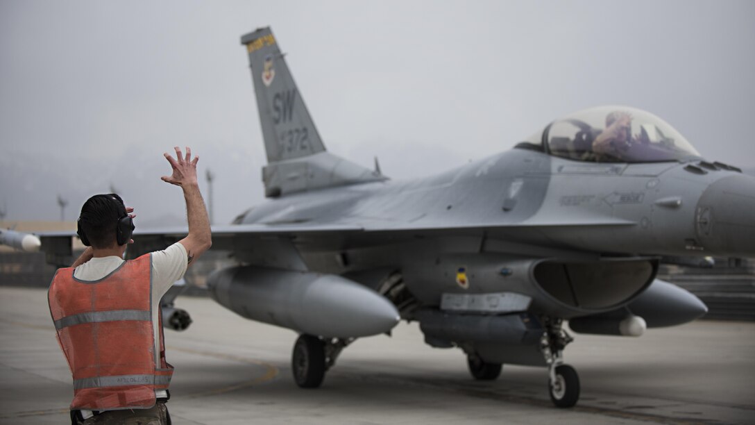 Staff Sgt. Ryan Best, 455th Expeditionary Aircraft Maintenance Squadron weapons load crew member, and Lt. Col. Craig Andrle, 79th Expeditionary Fighter Squadron commander, show tiger claws, representing the fighter squadron’s mascot, after a combat sortie March 20, 2017 at Bagram Airfield, Afghanistan. Andrle reached a milestone 1,000 combat hours while supporting the wing’s counterterrorism mission in Afghanistan. (U.S. Air Force photo by Staff Sgt. Katherine Spessa)