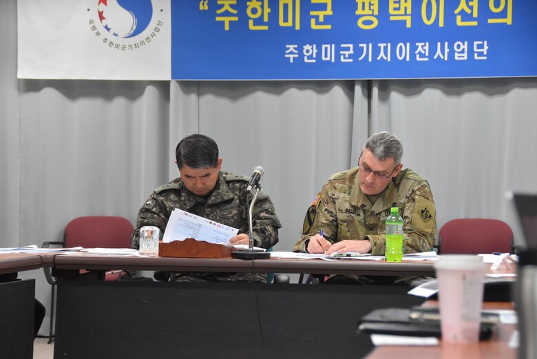 Brig. Gen. Dae-Nam Kang (left), Ministry of National Defense U.S. Forces Korea Relocation Office (MURO) chief and Col. Stephen Bales, US Army Corps of Engineers Far East District commander, take notes during a recent Tier II governance meeting held Mar. 29 at the Medical Resident Office, Camp Humphreys, South Korea. The meeting provided all organizations involved in the completion of the hospital project a chance to sync and discuss a completion date. 
