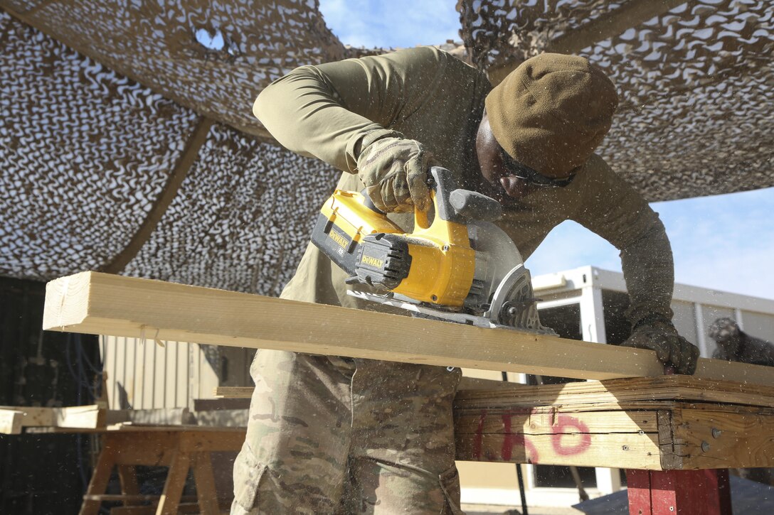 U.S. Army Specialist Dasean Epps, an engineer deployed in support of Combined Joint Task Force – Operation Inherent Resolve, assigned to 258th Engineering Utilities Detachment, saws through a two-by-four in support of daily operations at Task Force Al-Taqaddum in Iraq, Feb. 6, 2017. The detachment has constructed permanent structures for the personnel of the Task Force. Task Force Al-Taqaddum trains Iraqi forces with operationally relevant training, an integral aspect of Combined Joint Task Force - Operation Inherent Resolve, the global coalition to defeat ISIS in Iraq and Syria. (U.S. Marine Corps photo by Lance Cpl. Joshua McAlpine) 