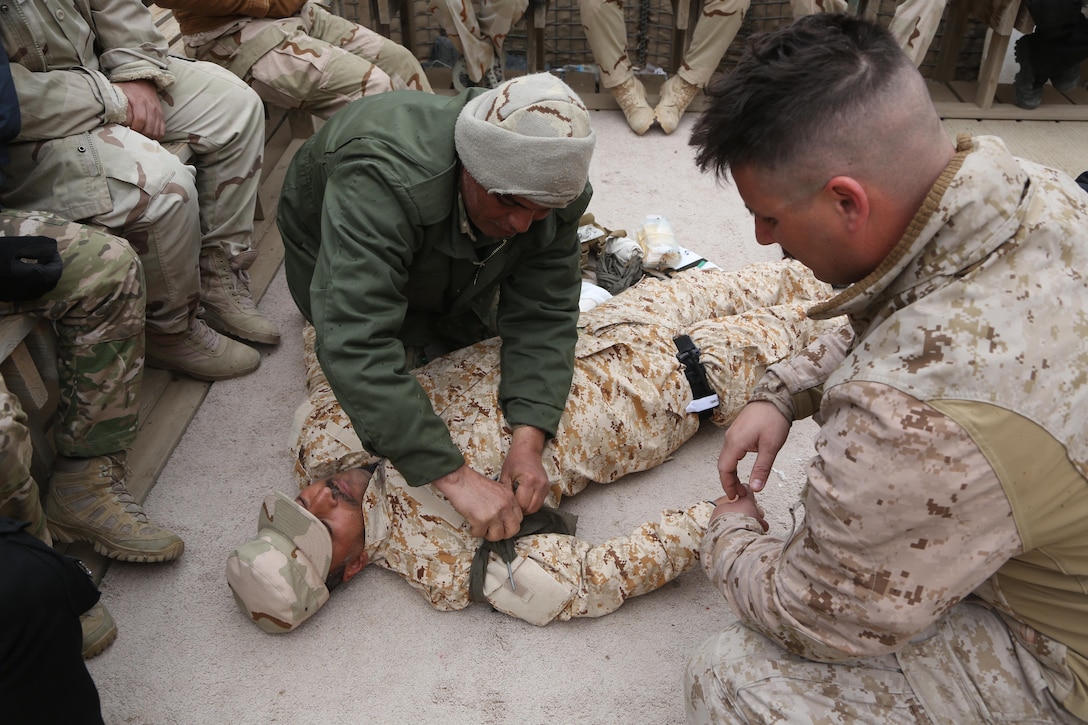 U.S. Navy Hospital Corpsman Petty Officer 1st Class Jeric Martin, a medical advisor with Task Force Al-Taqaddum, deployed in support of Combined Joint Task Force – Operation Inherent Resolve, observes an Iraqi soldier applying an improvised tourniquet while implementing proper combat lifesaving techniques in Iraq, Feb. 7, 2017. Task Force Al-Taqaddum trains Iraqi forces with operationally relevant training, an integral aspect of Combined Joint Task Force - Operation Inherent Resolve, the global coalition to defeat ISIS in Iraq and Syria. (U.S. Marine Corps photo by Lance Cpl. Joshua McAlpine) 