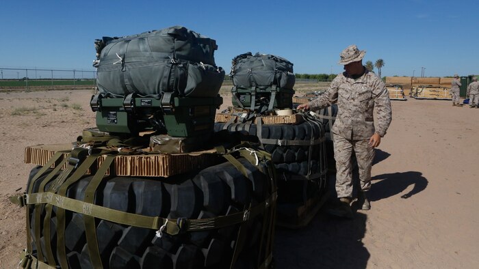 U.S Marine Pfc. Brad A. Clark inspects the rigged aerial delivery systems of Joint Precision Airdrops during a Weapons and Training Instructor Course March 30, 2017, at Marine Corps Air Station Yuma, Ariz. Clark is an airborne delivery specialist with 2nd Transportation Support Battalion, 2nd Marine Logistics Group. The JPADS uses a GPS system and a modular autonomous guidance unit to get to their targeted drop zones.