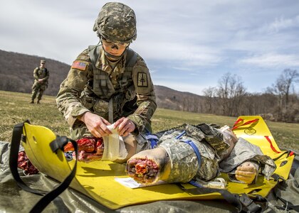 U.S. Army Spc. Courtney Natal provides aid to a simulated casualty during the New York Army National Guard Best Warrior Competition at Camp Smith Training Site March 30, 2017. The Best Warrior competitors represent each of New York's brigades after winning competitions at the company, battalion, and brigade levels. At the state level they are tested on their physical fitness, military knowledge, endurance, marksmanship, and land navigation skills. The two winners of the competition, one junior enlisted and one NCO, advance to compete at the regional level later this year. 