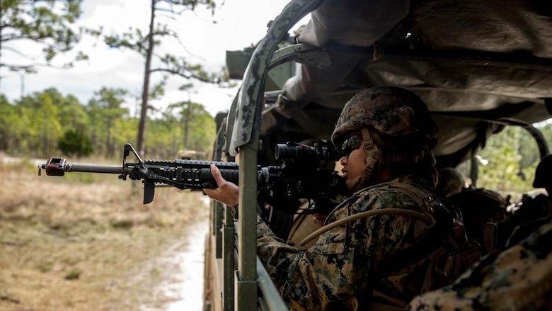 Pfc. Kaneisha Pinkney sights in with an M16A4 rifle to look for simulated enemies at Marine Corps Base Camp Lejeune, N.C., March 29, 2017. The Marines conducted a combat convoy exercise as part of the Combat Logistics Regiment 25 Command Post Exercise. Pinkney is with CLR-25, 2nd Marine Logistics Group. 