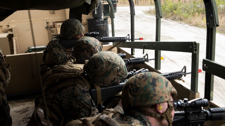 Marines sight in their M16A4 rifles in the bed of a Medium Tactical Vehicle Replacement truck at Marine Corps Base Camp Lejeune, N.C., March 29, 2017. The Marines conducted a combat convoy exercise as part of the Combat Logistics Regiment 25 Command Post Exercise. The Marines are with CLR-25, 2nd Marine Logistics Group. 