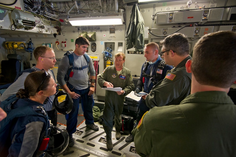 Lt. Col. Mike Parker, deputy chief of standards and evaluation with 315th Operations Group, Joint Base Charleston, South Carolina, discusses pre-flight details with aircrew and Wings of Blue jumpmasters prior to the morning jump training exercise. Citizen Airmen from the 701st Airlift Squadron conducted airdrop training with the Wings of Blue, the U.S. Air Force's parachute team, April 1, 2017 in Phoenix, Ariz. (U.S. Air Force photo by TSgt. Bobby Pilch)