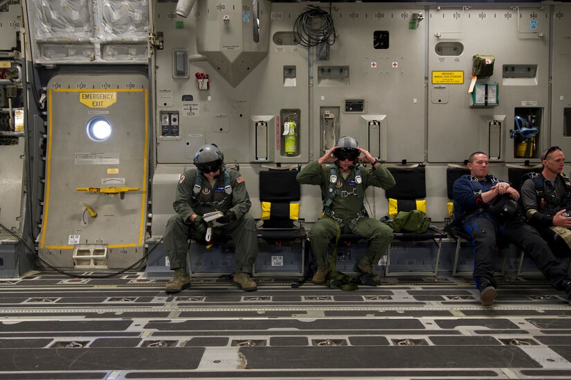 Tech. Sgt. Travis Nettles (left) and Staff Sgt. Lee Hiott (right), loadmasters assigned to the 701st Airlift Squadron, Joint Base Charleston, South Carolina, review checklists and perform equipment checks prior to executing an airdrop with the Wings of Blue. Citizen Airmen from the 701st Airlift Squadron conducted airdrop training with the Wings of Blue, the U.S. Air Force's parachute team, April 1, 2017 in Phoenix, Ariz. (U.S. Air Force photo by TSgt. Bobby Pilch)