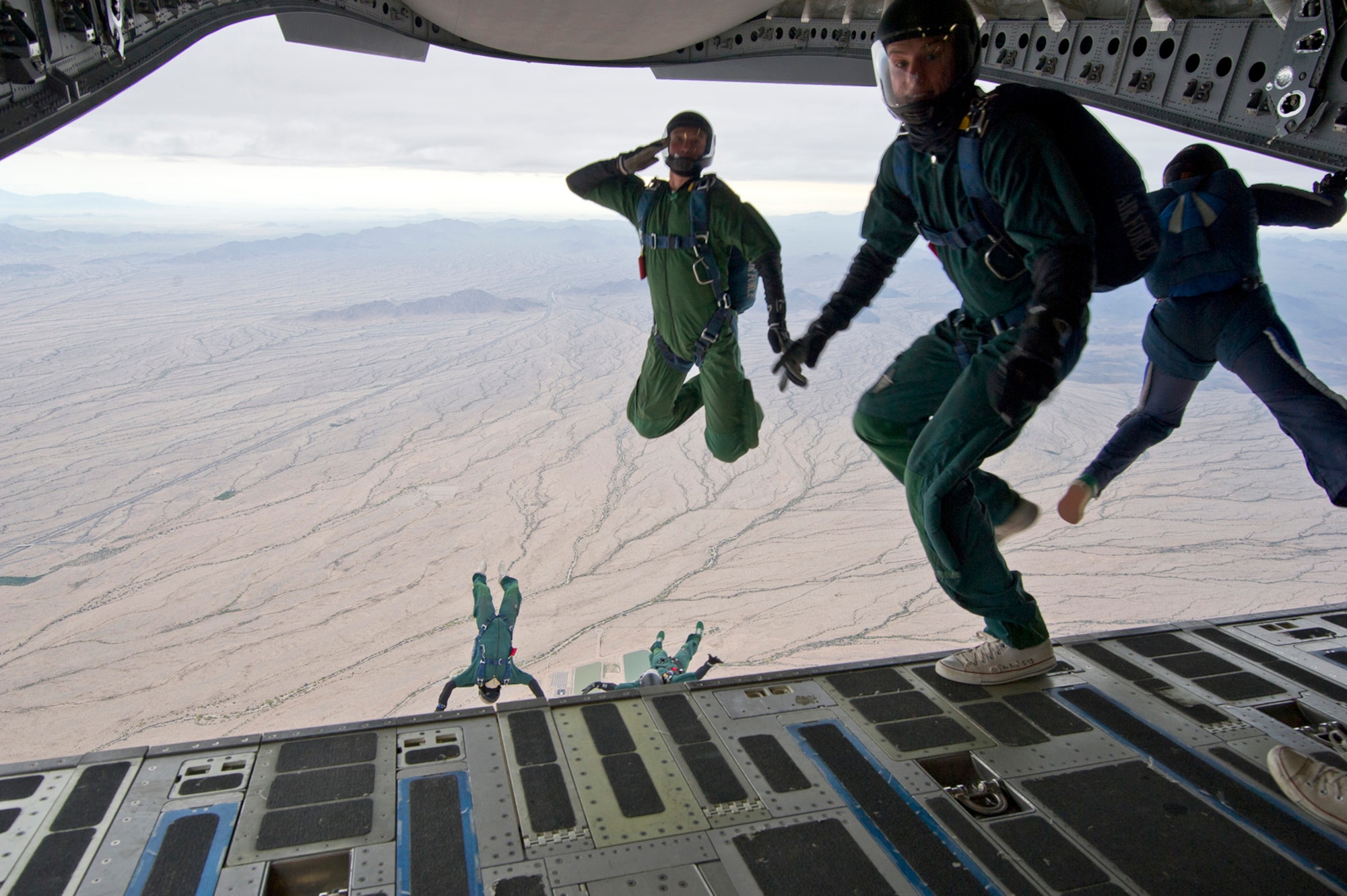 Members from the Wings of Blue and Wings of Green parachute team, depart a Charleston-based C-17 aircraft during their Spring Break training exercise over the Arizona desert. Citizen Airmen from the 701st Airlift Squadron conducted airdrop training with the Wings of Blue, the U.S. Air Force's parachute team, April 1, 2017 in Phoenix, Ariz. (U.S. Air Force photo by TSgt. Bobby Pilch)