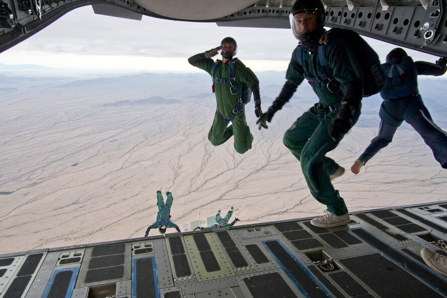 Members from the Wings of Blue and Wings of Green parachute team depart a C-17 GlobemasterIII during their Spring break training exercise over the Arizona desert. Citizen Airmen from the 701st Airlift Squadron conducted airdrop training with the Wings of Blue, the U.S. Air Force's parachute team, April 1, 2017 in Phoenix, Ariz. (U.S. Air Force photo/Tech. Sgt. Bobby Pilch)