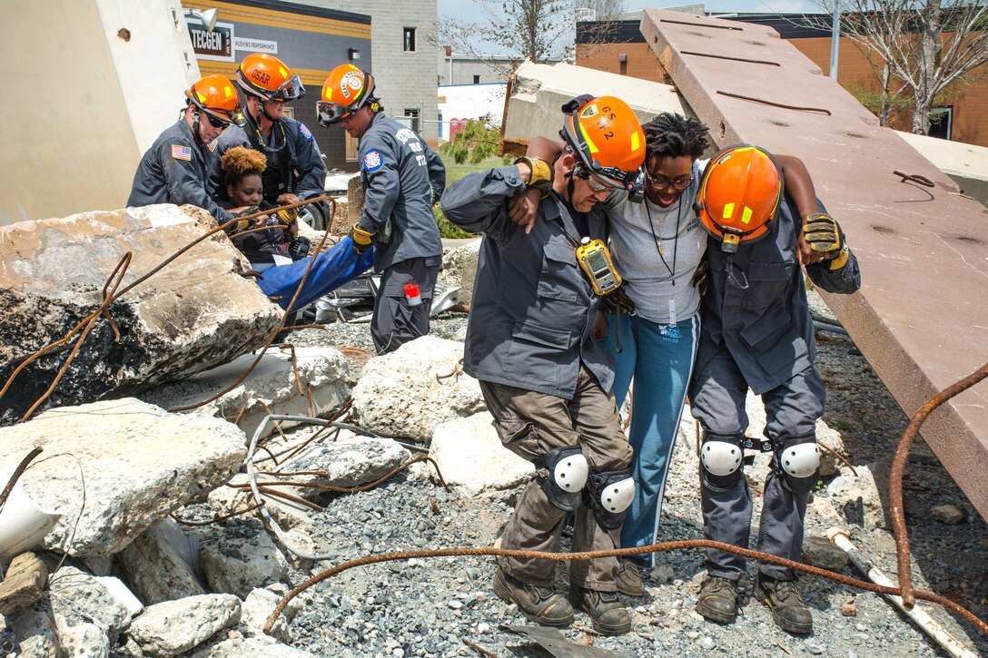 Members of the Georgia Search and Rescue Task Force 2 assist mock casualties from a collapsed building during Operation Vigilant Guard at the Guardian Center in Perry, Georgia, March 29, 2017. Army photo by Pfc. Darion Gibson