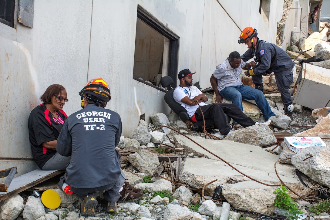 Members of the Georgia Search and Rescue Task Force 2 assist mock casualties from a collapsed building during Operation Vigilant Guard at the Guardian Center in Perry, Georgia, March 29, 2017. Army photo by Pfc. Darion Gibson