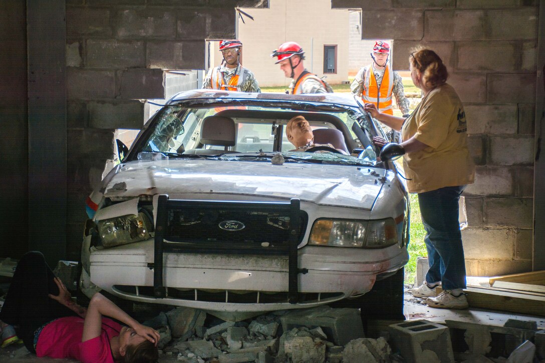 Georgia Army National Guard members assist mock casualties in a vehicle that crashed through a wall during Operation Vigilant Guard at the Guardian Center in Perry, Georgia, March 29, 2017. Army photo by Pfc. Darion Gibson