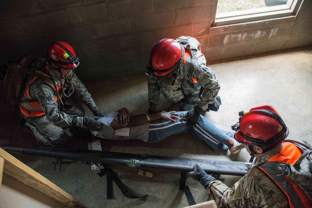 Georgia Army and Air National Guard members prepare to place a mock casualty onto a stretcher during Operation Vigilant Guard at the Guardian Center in Perry, Georgia, March 29, 2017. Army photo by Pfc. Darion Gibson