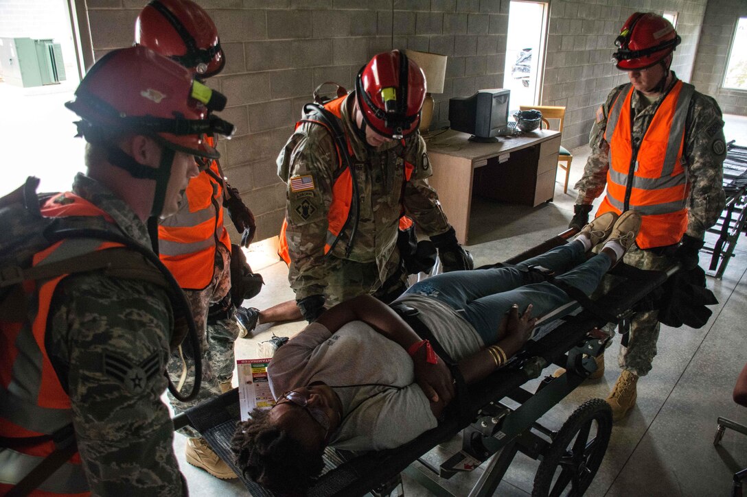 Georgia Army and Air National Guard members place a mock casualty onto a stretcher during Operation Vigilant Guard at the Guardian Center in Perry, Georgia, March 29, 2017. Army photo by Pfc. Darion Gibson