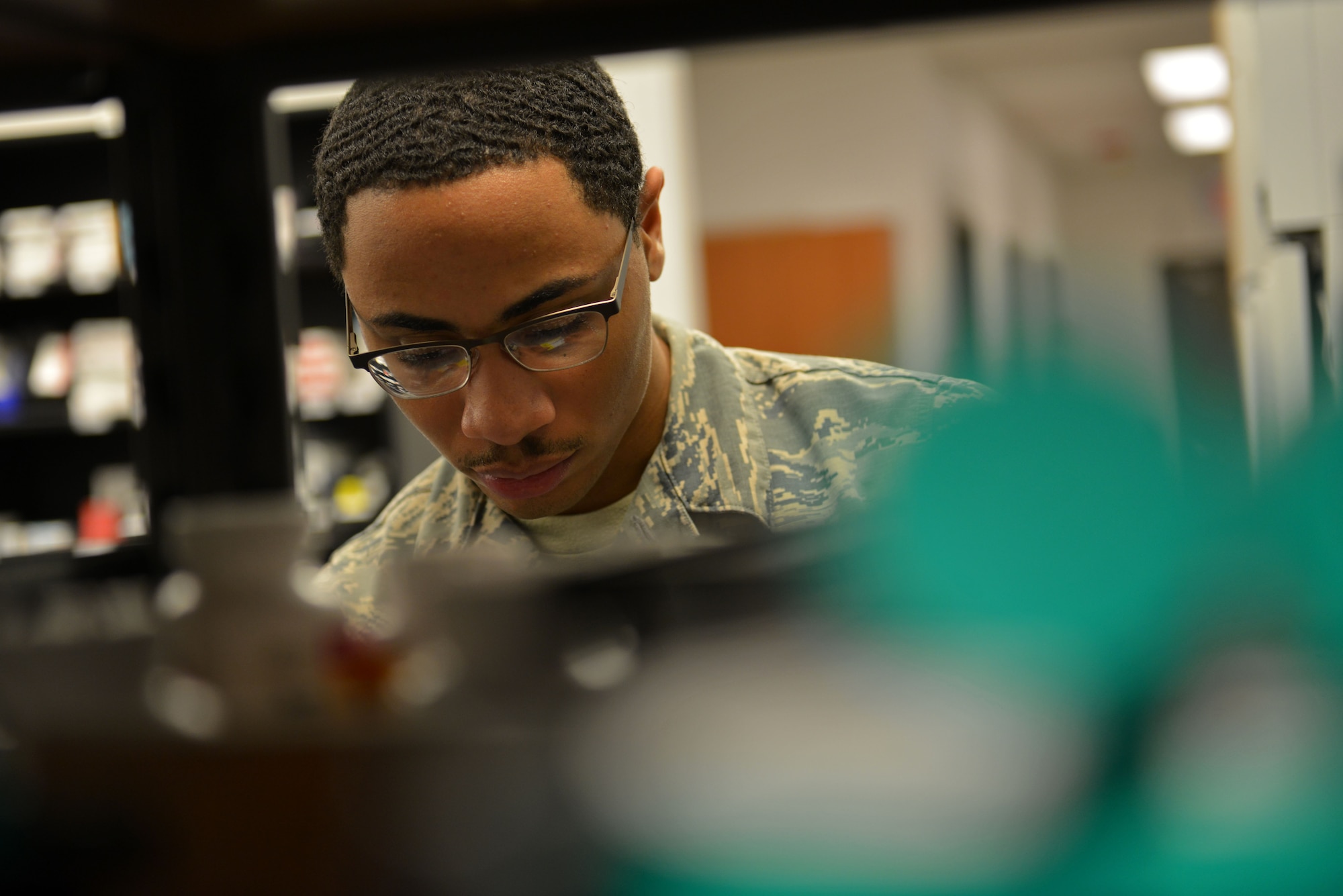 U.S. Air Force Airman 1st Class Torren Farg, 20th Medical Support Squadron pharmacy technician, looks for a specific medication at Shaw Air Force Base, S.C., March 29, 2017. Farg works at the Shaw Exchange pharmacy, helping to provide patients with the proper medication. (U.S. Air Force photo by Airman 1st Class Destinee Sweeney)
