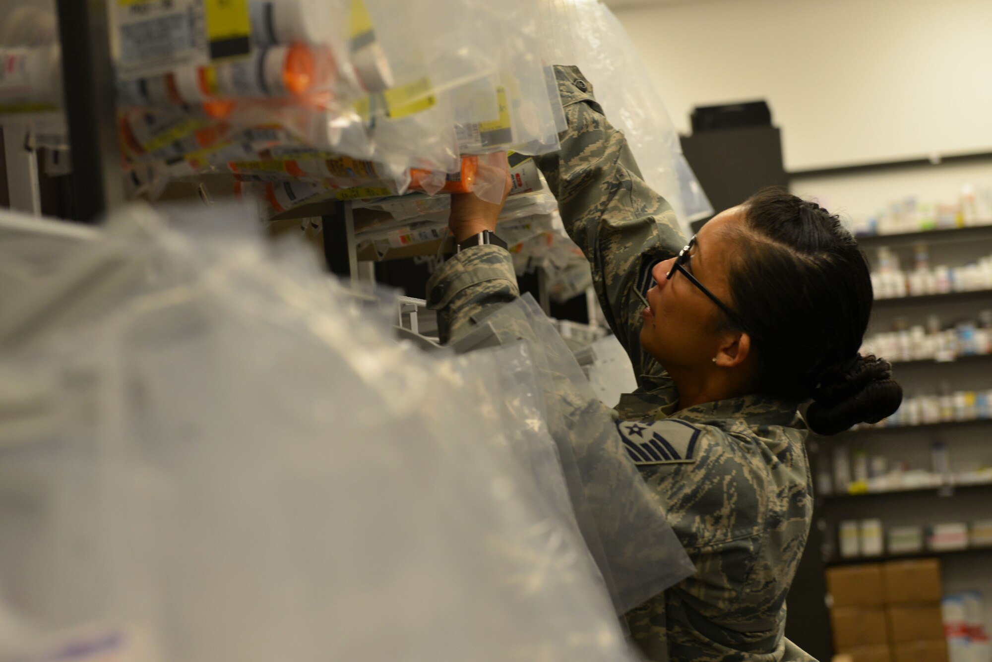 U.S. Air Force Master Sgt. Christine Orona, 20th Medical Support Squadron pharmacy services noncommissioned officer in charge, retrieves a patient’s filled prescription from a rack at Shaw Air Force Base, S.C., March 29, 2017. The Shaw Exchange pharmacy provides customer service and required medications for service members, retirees and their families. (U.S. Air Force photo by Airman 1st Class Destinee Sweeney)