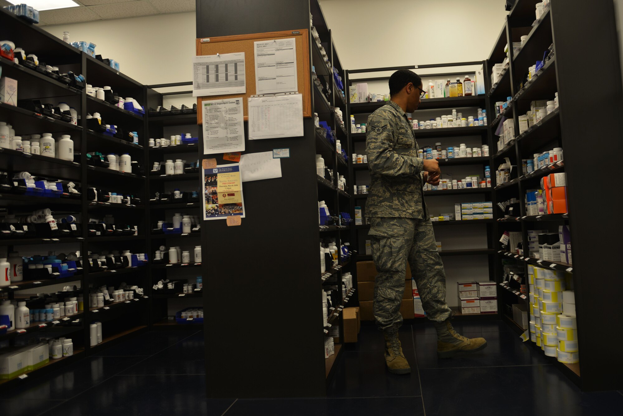 U.S. Air Force Airman 1st Class Torren Farg, 20th Medical Support Squadron pharmacy technician, looks through aisles of medication at Shaw Air Force Base, S.C., March 29, 2017. The Shaw Exchange pharmacy serves approximately 33,000 patients including service members, retirees and their families. (U.S. Air Force photo by Airman 1st Class Destinee Sweeney)