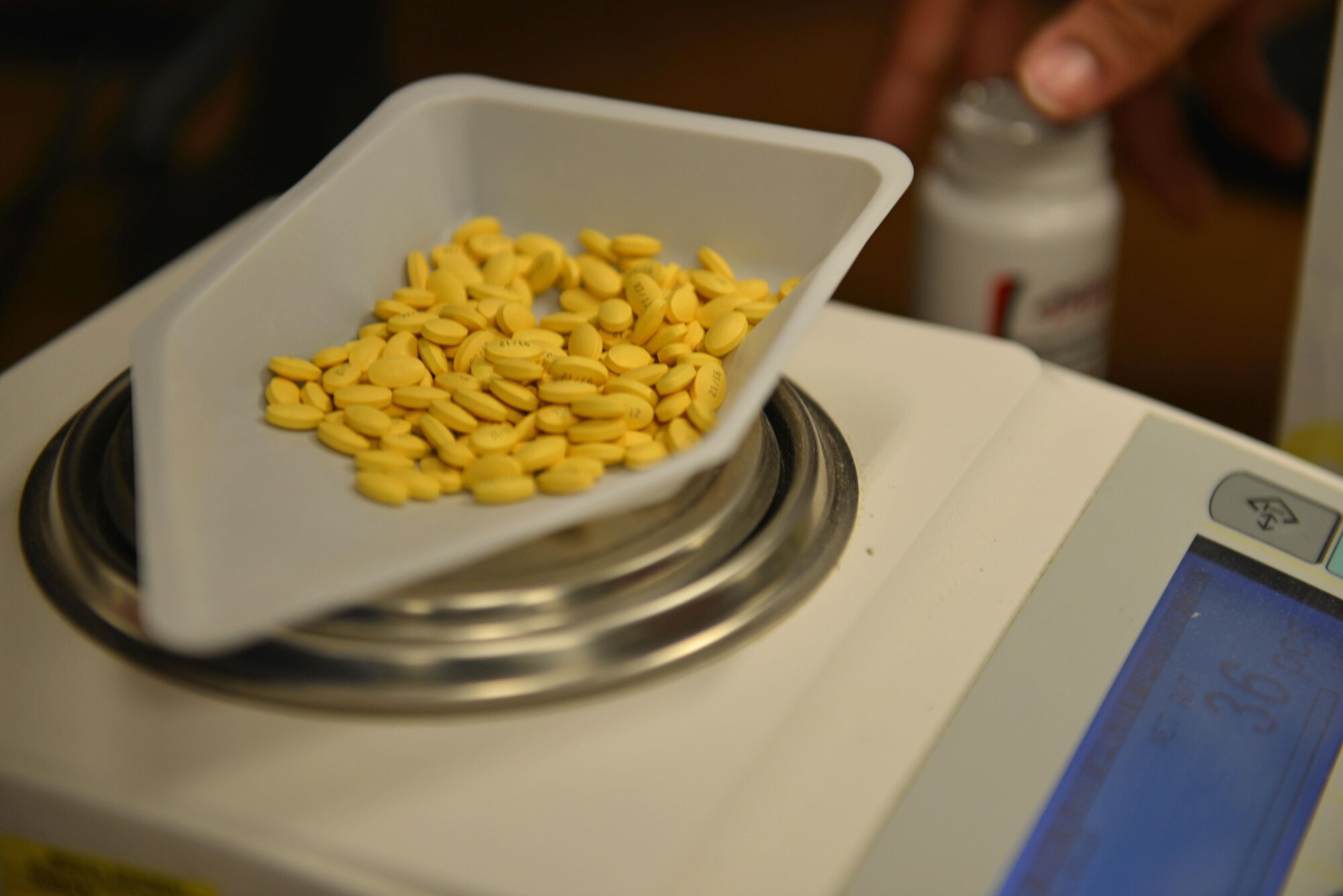 Pills lay on top of an automated scale at Shaw Air Force Base, S.C., March 29, 2017. The scale is capable of reading a medication barcode and using the known weight of a specific pill to calculate the number of pills being distributed to patients. (U.S. Air Force photo by Airman 1st Class Destinee Sweeney)