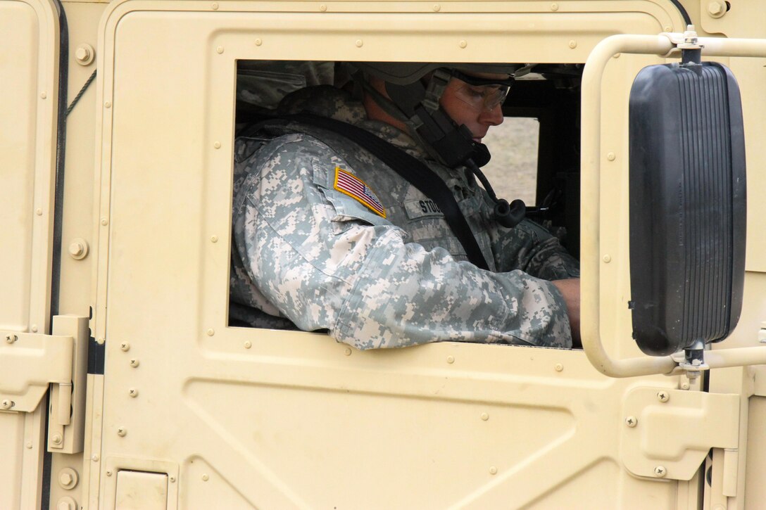 U.S. Army Reserve Sgt. Michael Stoops, 318th Tactical Psychological Operations Company, U.S. Army Civil Affairs and Psychological Operations Command, puts his gloves while waiting in a vehicle to begin live-fire qualification during Operation Cold Steel at Fort McCoy, Wis., March 31, 2017. Operation Cold Steel is the U.S. Army Reserve's crew-served weapons qualification and validation exercise to ensure that America's Army Reserve units and Soldiers are trained and ready to deploy on short-notice and bring combat-ready and lethal firepower in support of the Army and our joint partners anywhere in the world. (U.S. Army Reserve photo by Staff Sgt. Debralee Best, 84th Training Command)