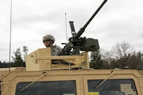 U.S. Army Reserve Sgt. Dennis Hoffman, 318th Tactical Psychological Operations Company, U.S. Army Civil Affairs and Psychological Operations Command, talks with his vehicle commander while preparing for live-fire qualification during Operation Cold Steel at Fort McCoy, Wis., March 31, 2017. Operation Cold Steel is the U.S. Army Reserve's crew-served weapons qualification and validation exercise to ensure that America's Army Reserve units and Soldiers are trained and ready to deploy on short-notice and bring combat-ready and lethal firepower in support of the Army and our joint partners anywhere in the world. (U.S. Army Reserve photo by Staff Sgt. Debralee Best, 84th Training Command)