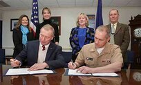 James Russell, president and CEO of the New Bedford Whaling Museum  and Capt. Michael Coughlin, NUWC Division Newport commanding officer, sign an Education Partnership Agreement for undersea acoustic research on March 31. Looking on are NUWC Division Newport marine mammal biologist Monica DeAngelis (from left); Christina Connett, New Bedford Whaling Museum curator of Exhibitions & Collections; NUWC Division Newport Technical Director Mary Wohlgemuth; and NUWC Division Newport marine biologist Thomas Fetherston.