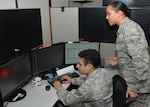 Analysts from the 453rd Electronic Warfare Squadron validate results from an automated flagging process called data-mining March 31, 2017, at Joint Base San Antonio-Lackland, Texas. Data-mining allows analysts to validate automated results rather than manually sifting through all the data.  (U.S. Air Force Photo by Lori Bultman/released)